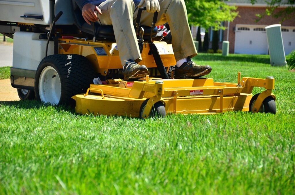 photo of a person driving a riding mower. Bryan Clayton took the photo